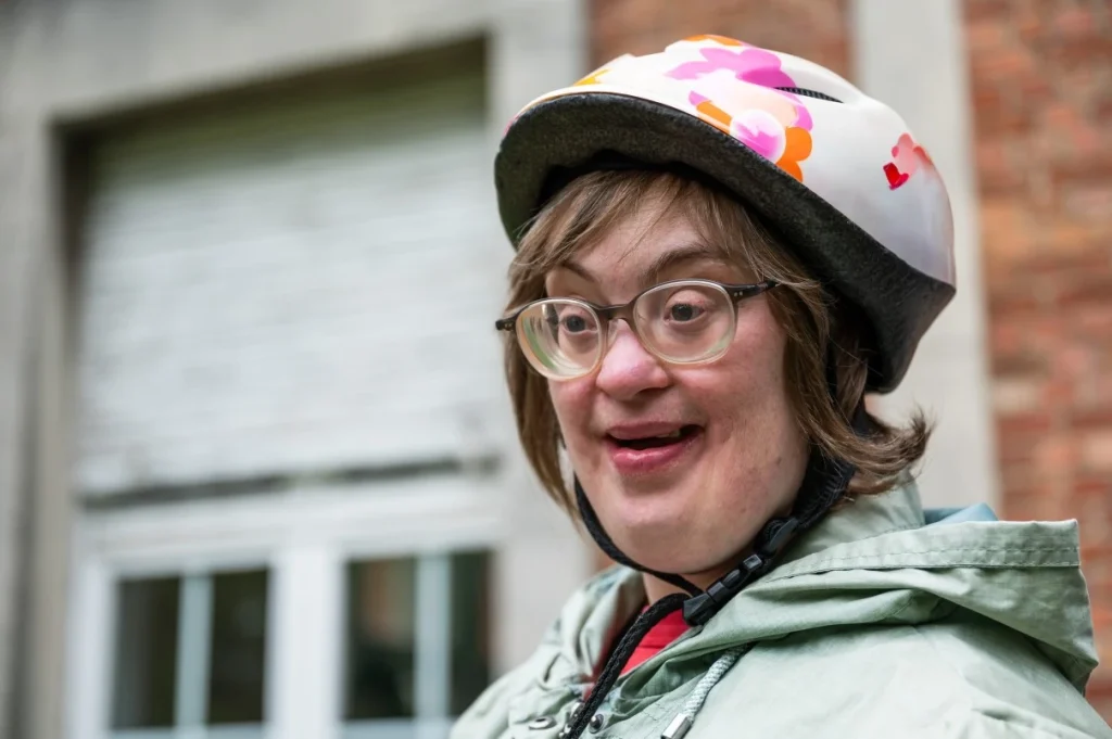 Happy disabled woman wearing helmet and smiling